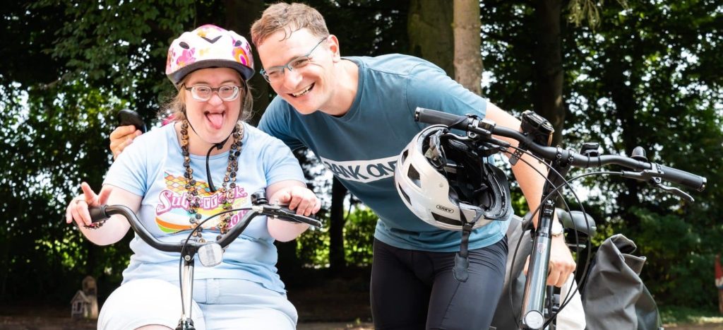 Preparing for MRI or PET scans 1 Woman with Down syndrome and her brother riding bikes in a park